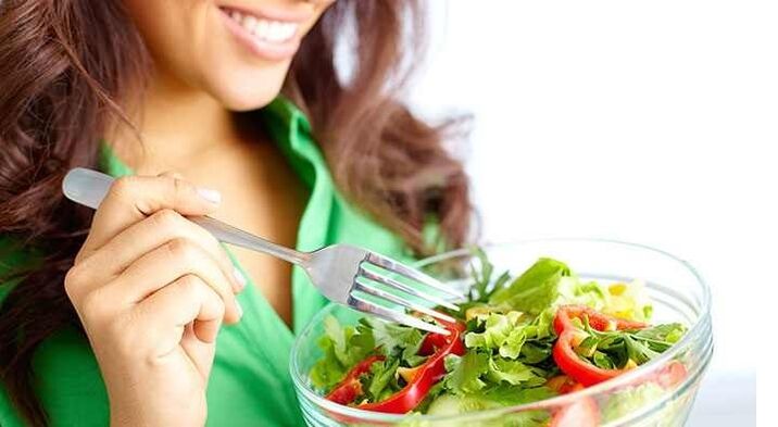 girl eats vegetable salad on a protein diet